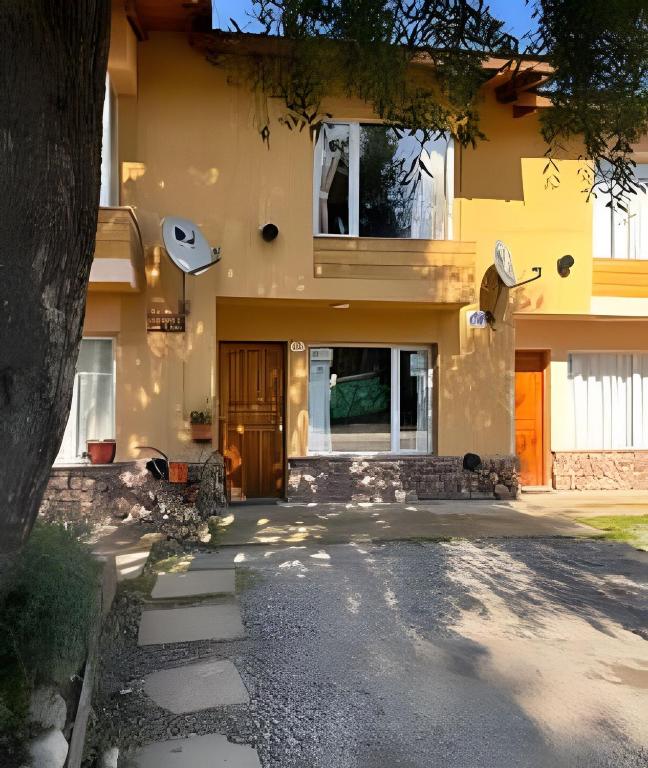 a house with a driveway in front of it at Copos de Nieve in El Bolsón