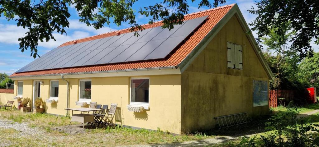 an old house with solar panels on the roof at Molsness in Knebel