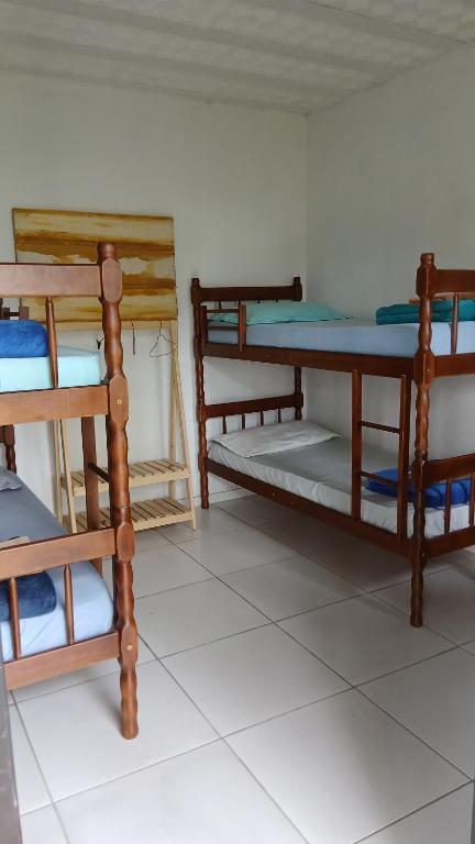 a room with three bunk beds in a room at Pousada Costeira Barra do Sul in Balneario Barra do Sul