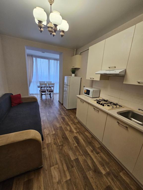 a kitchen with a couch and a kitchen with a table at Яровиця 61 in Lutsk