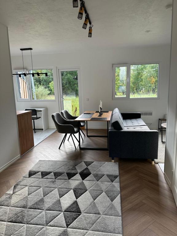 a living room with a couch and a table at Aurora Apartament in Inari