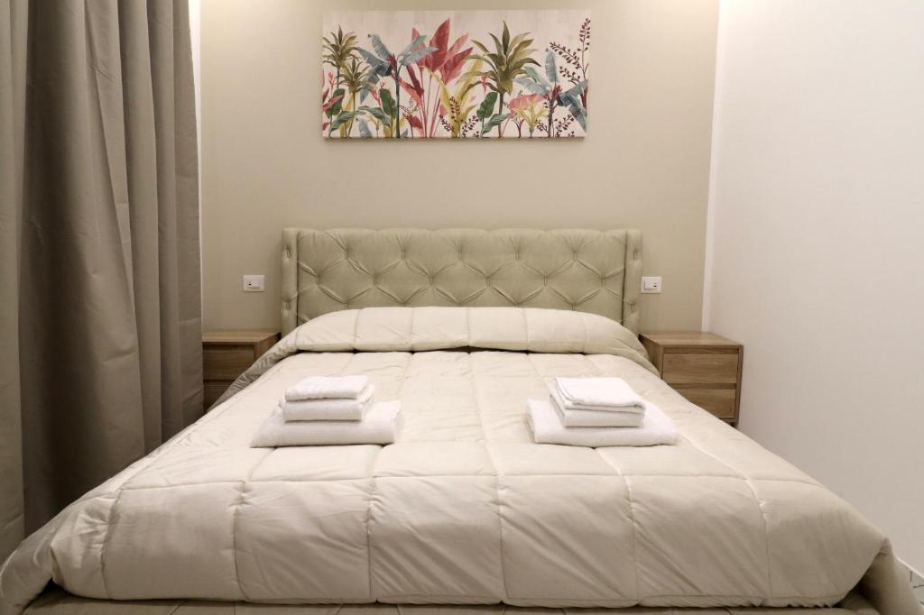 a bedroom with a large bed with white sheets at b&b la cattedrale in Avezzano