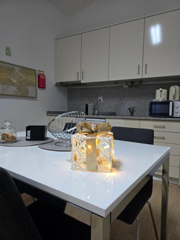 a white table with a gift on it in a kitchen at My Dream in Penha Garcia