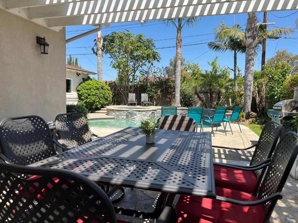 a table and chairs on a patio with a pool at Destination #23 in Anaheim