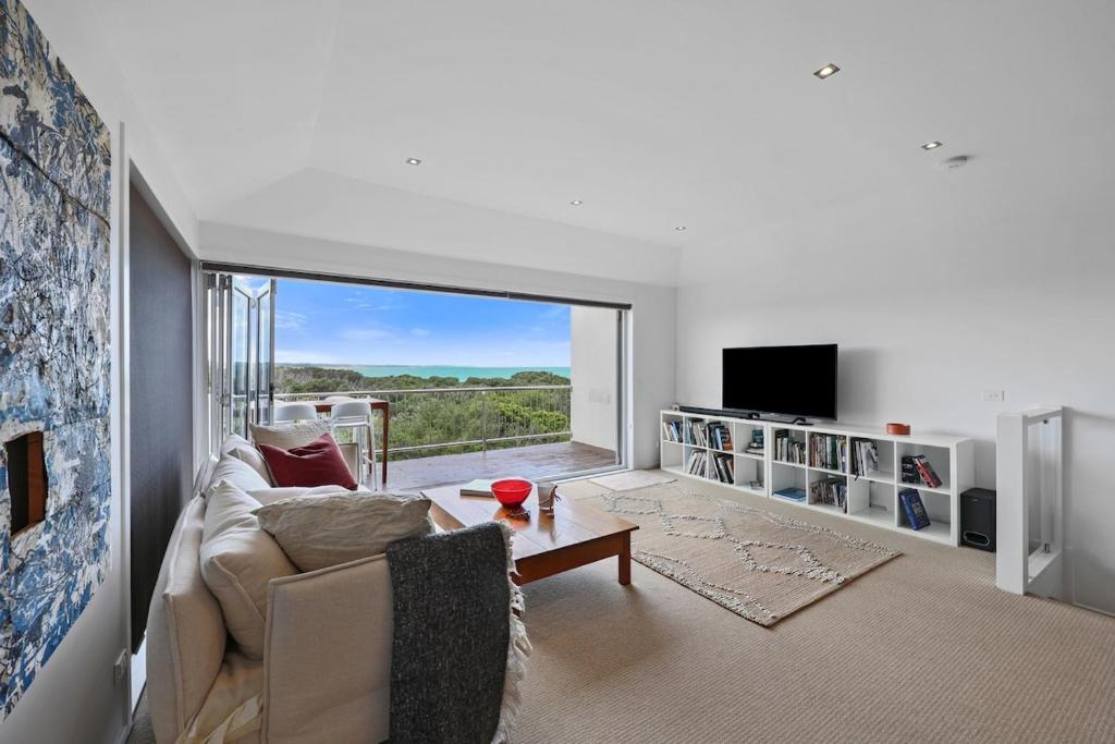 a living room with a couch and a tv at Barbro Warrnambool in Warrnambool