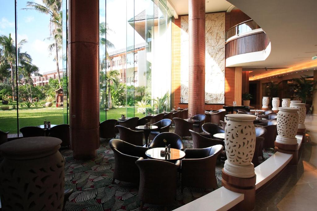 a restaurant with chairs and tables in a building at Caesar Park Hotel Kenting in Kenting