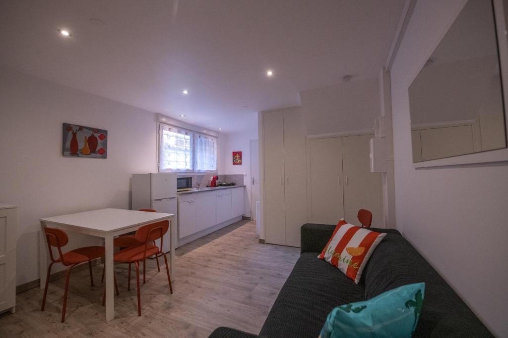 a living room with a couch and a table at Studio central 002B in Saint-Étienne