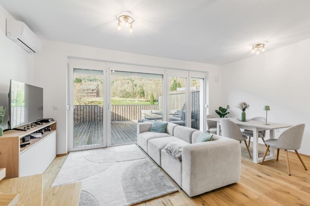 a living room with a couch and a table at Family Apartment Bovec with Free Parking in Bovec