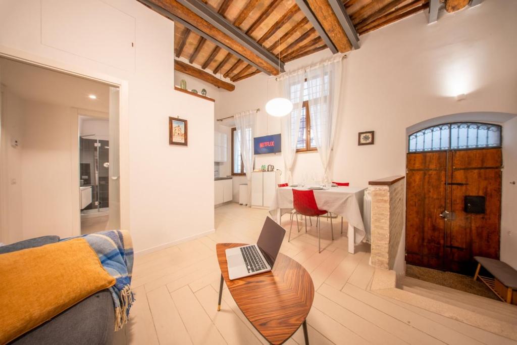 a living room with a laptop on a wooden table at Apartment in the historic center of Perugia in Perugia