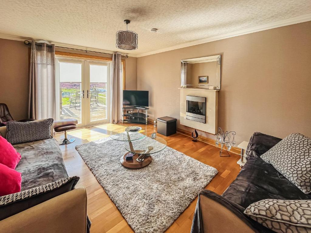 a living room with a couch and a table at Gramsdale House in Gramisdale