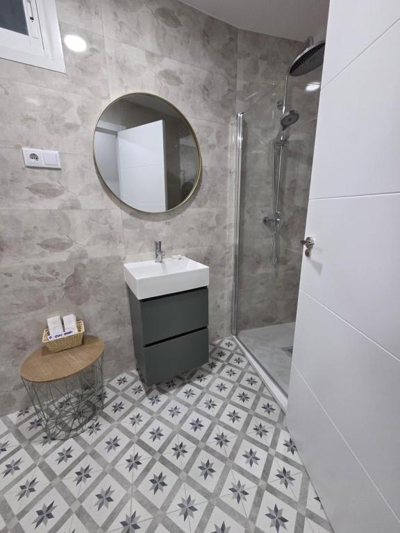 a bathroom with a sink and a mirror at Las Casitas de Jisa in Talavera de la Reina