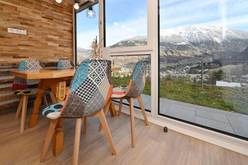 a room with a table and chairs and a large window at Rundblick 2 Gartenwohnung in Tschagguns