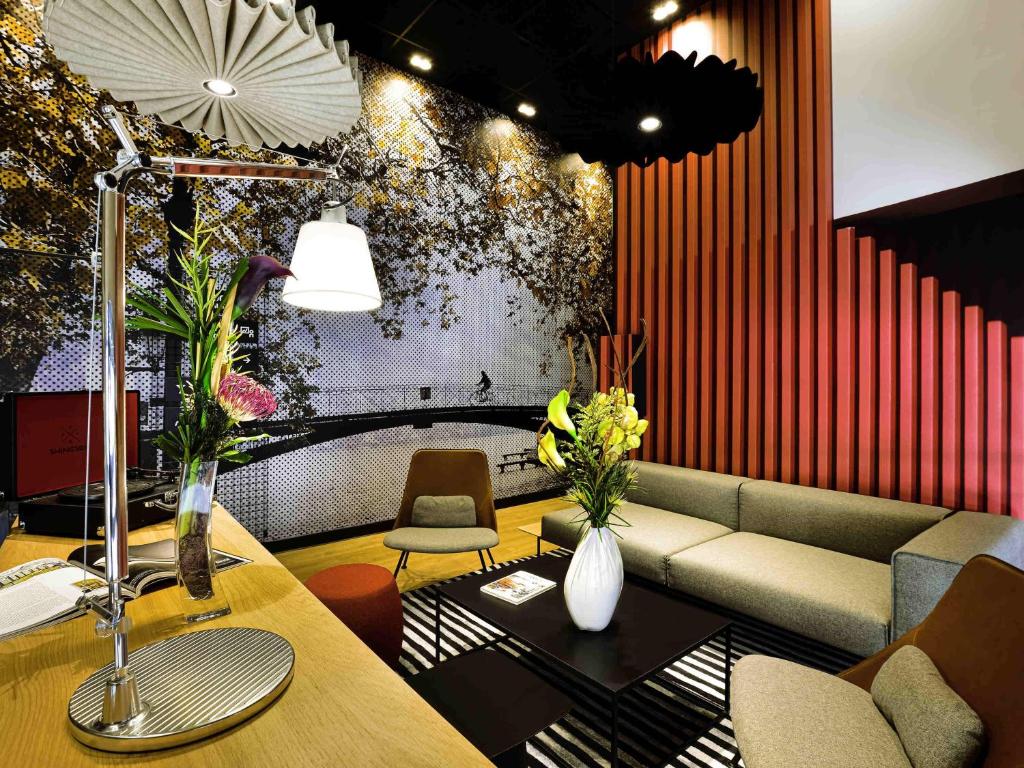 a living room with a couch and a table at Ibis Annecy - Cran-Gevrier in Annecy