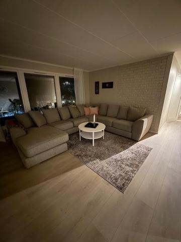 a living room with a couch and a table at Langhaugen - Kabelvåg in Kabelvåg