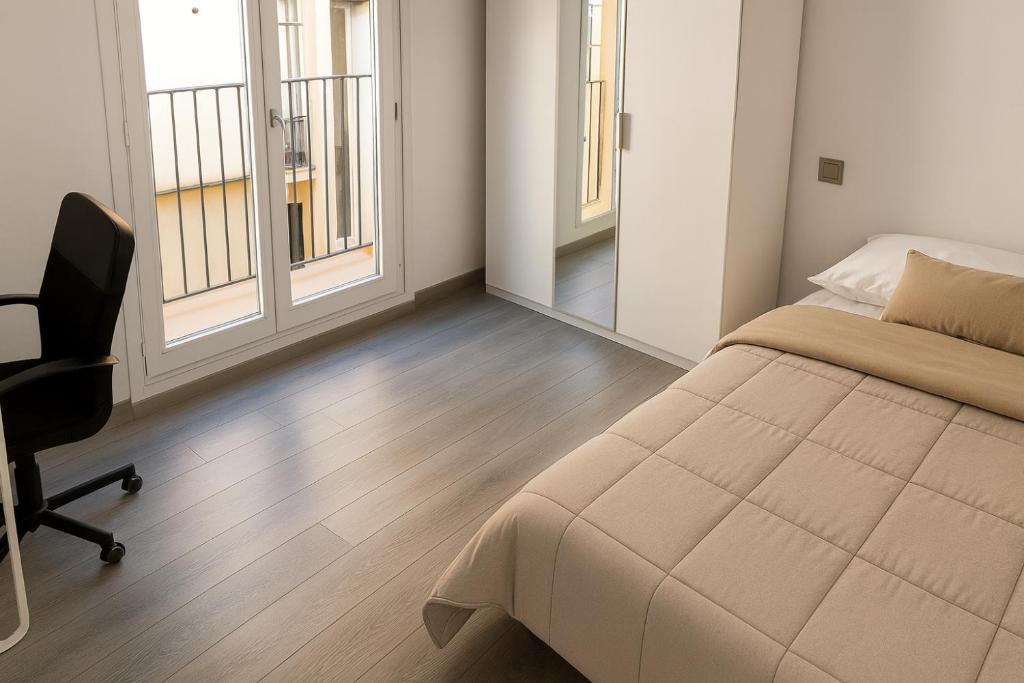 a bedroom with a bed and a chair and windows at MODERNO NUEVO Luminoso WI-FI PLAZA DEL PILAR 2 in Zaragoza