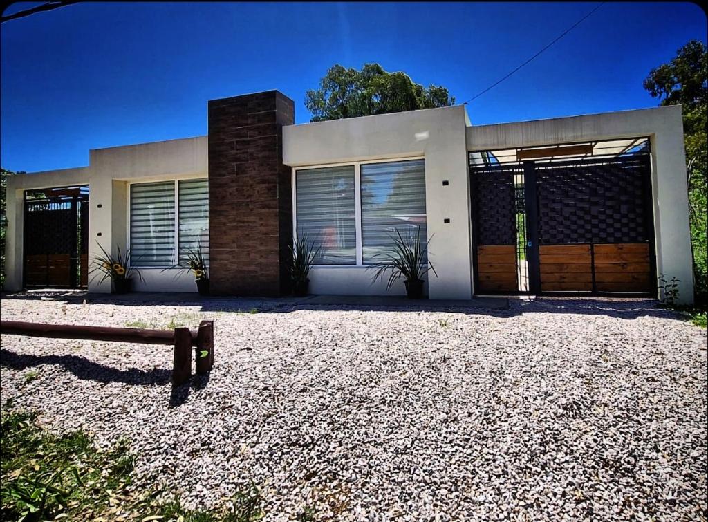 a house with a bench in front of it at Hermosa casa a estrenar en Playa Grande ELIXIR in San Gregorio de Polanco