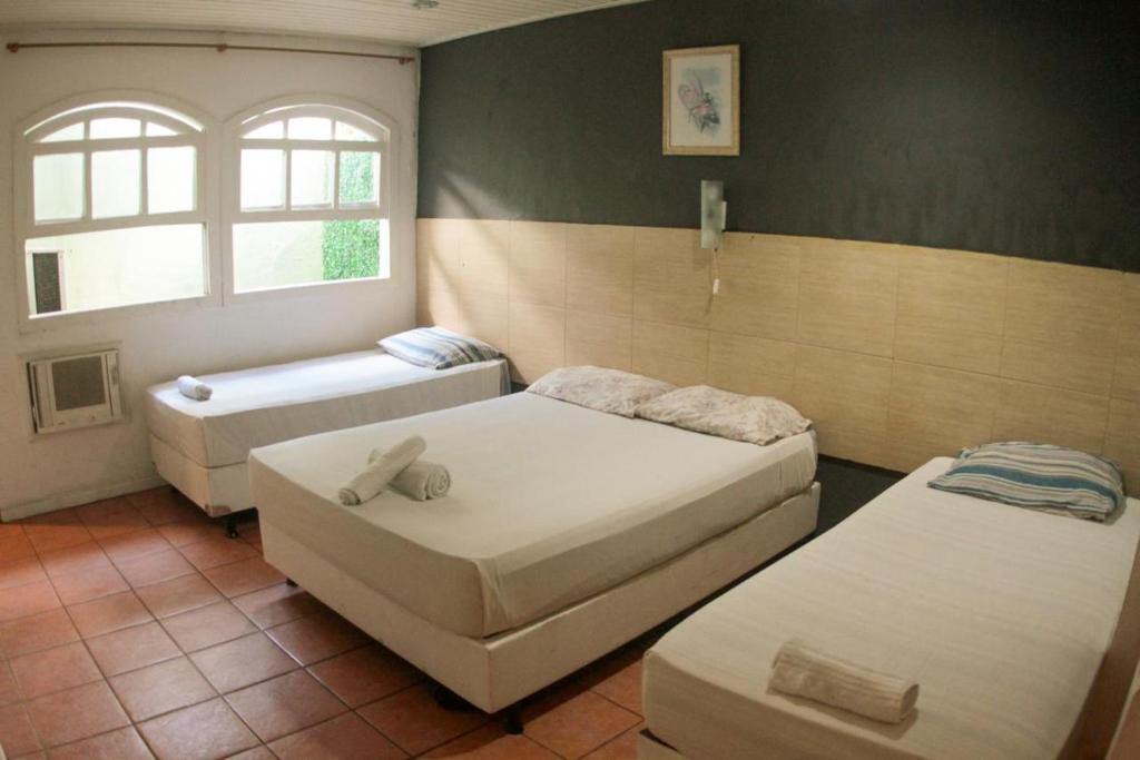 Ένα ή περισσότερα κρεβάτια σε δωμάτιο στο Pousada Casa Maré