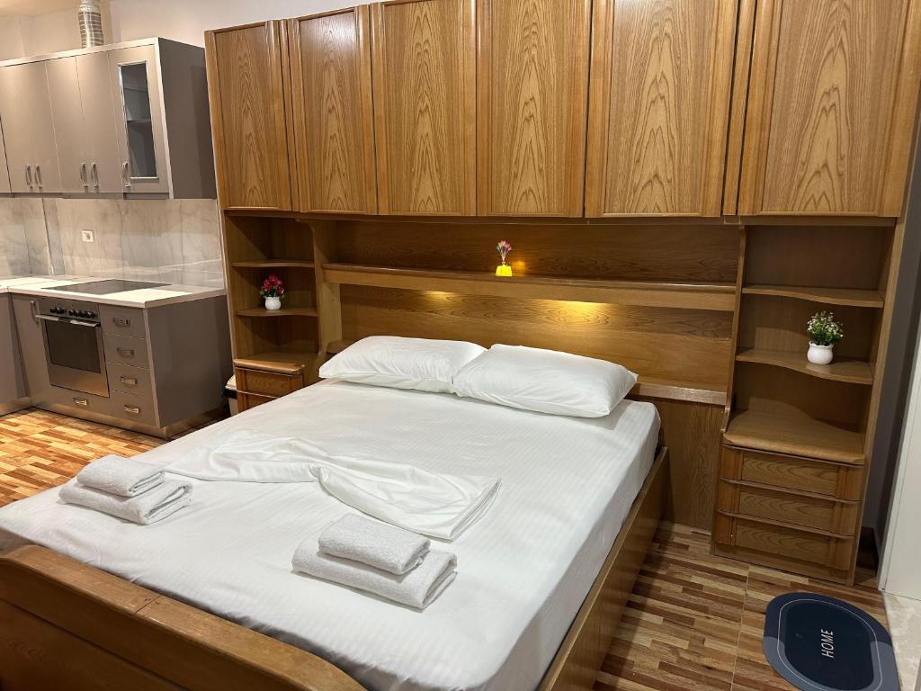 a bedroom with a bed with towels on it at Eyar house in Kamëz