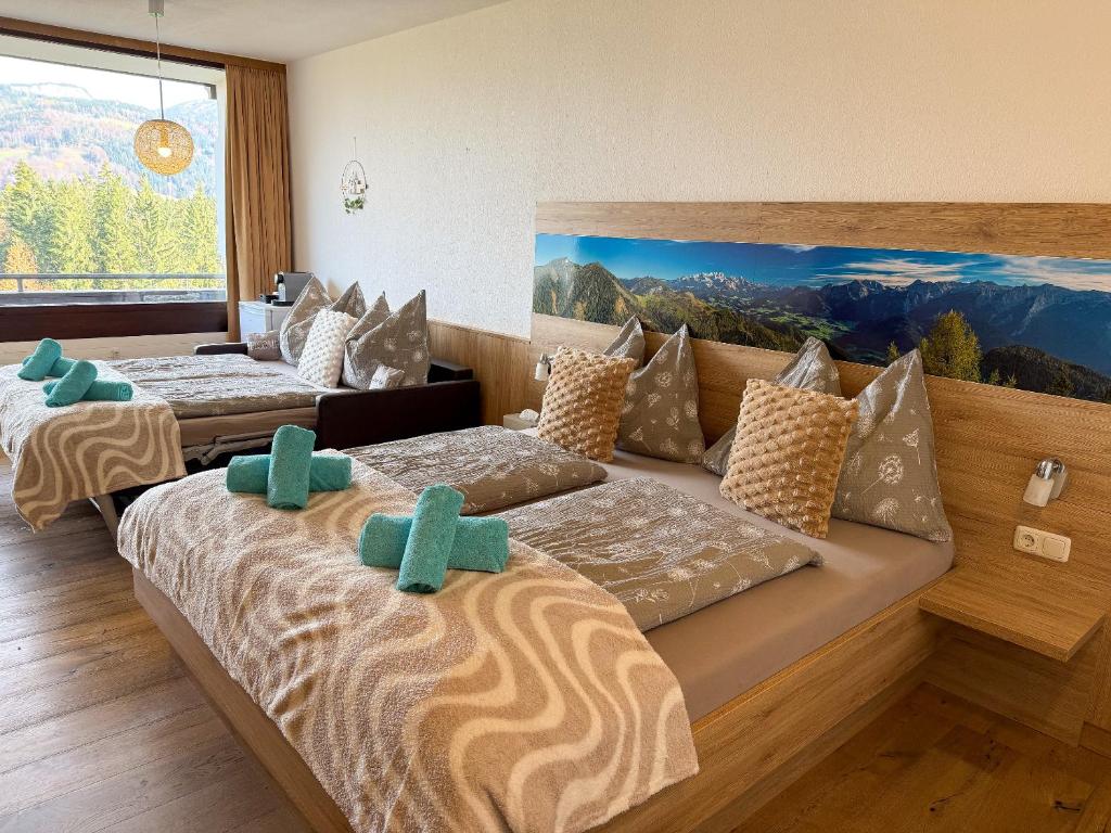 a room with three beds with green crosses on them at Appartement Oriold in Bad Goisern