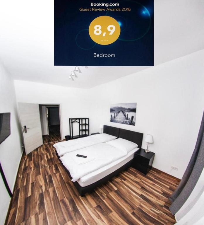 a bed in a room with a wooden floor at Bedroom in Nuremberg