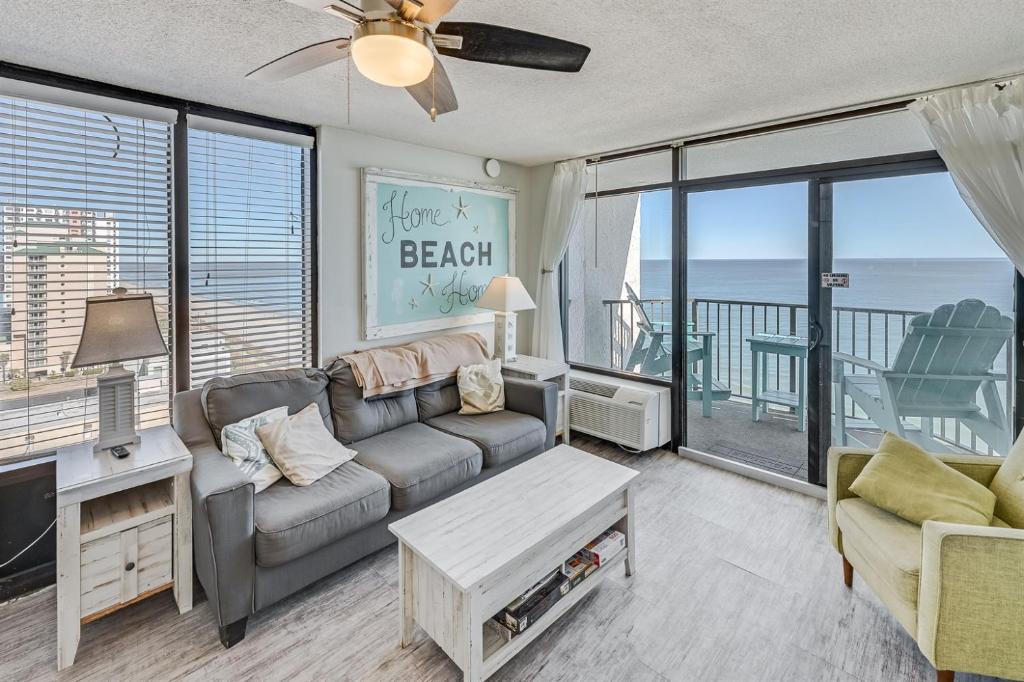 a living room with a couch and a view of the ocean at Pets welcome,direct oceanfront, poolside,1 bedroom in Myrtle Beach