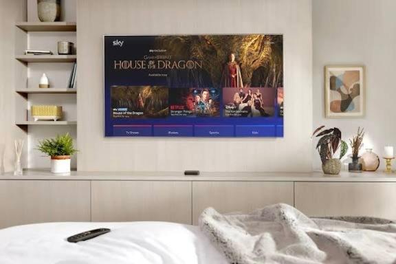 a bedroom with a movie poster on the wall at Stylish 2BD, Near O2, WIF, Sleeps 6, London in London