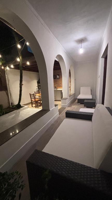 a living room with a bed and a kitchen at Palais House in São Vicente