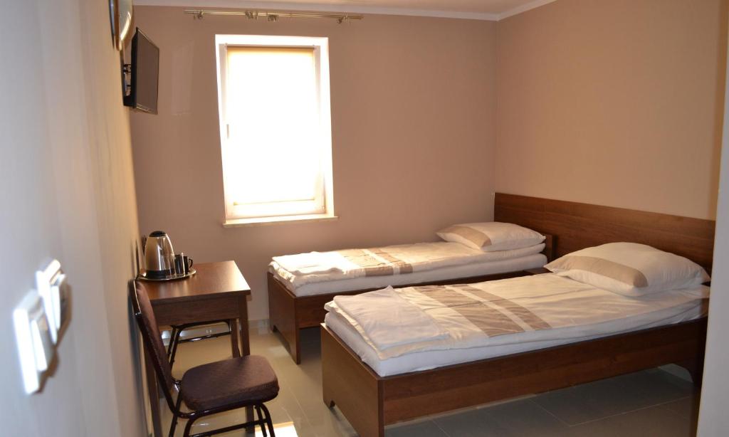Postel nebo postele na pokoji v ubytování Hotelik Karter