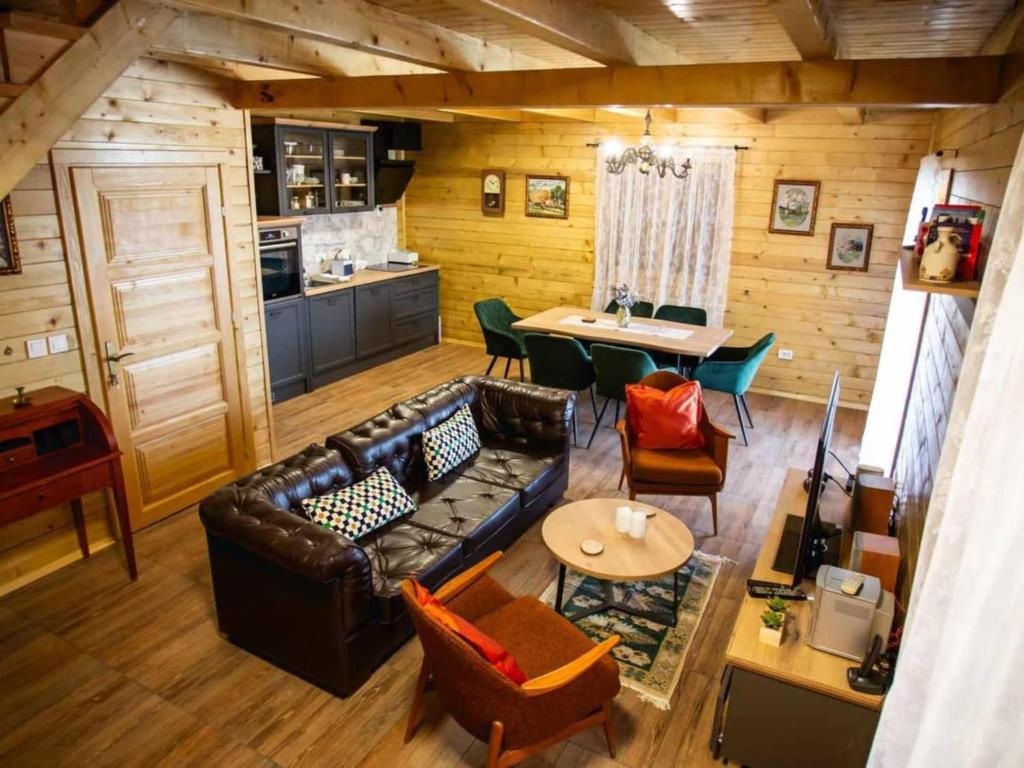 a living room with a couch and a table at Four bedroom villa in Vukovar