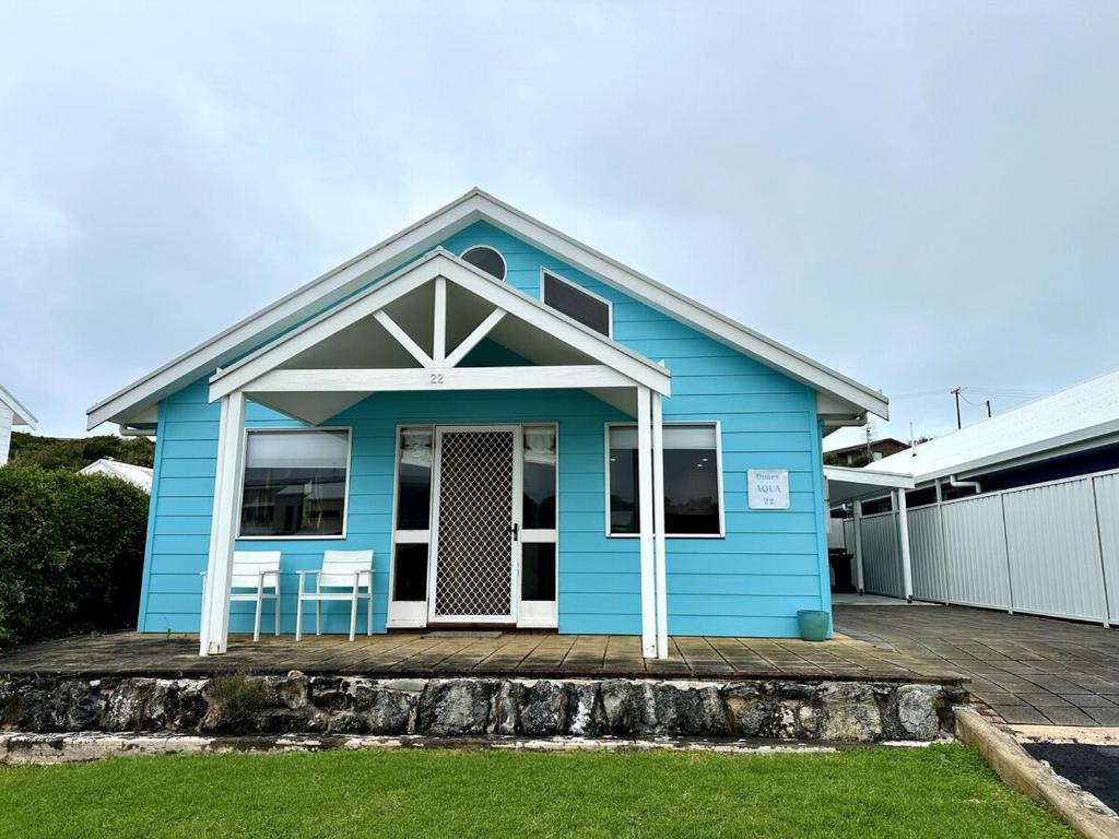 a blue house with two chairs in front of it at Dunes Aqua at Robe in Robe