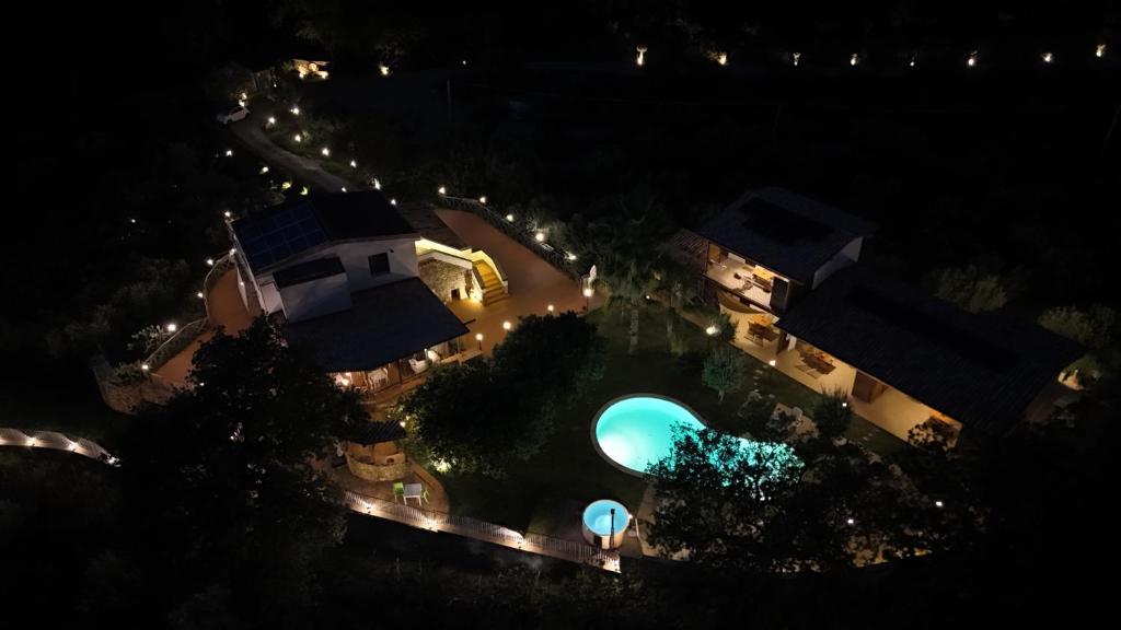 an overhead view of a swimming pool at night at Casale Calabria in Gizzeria