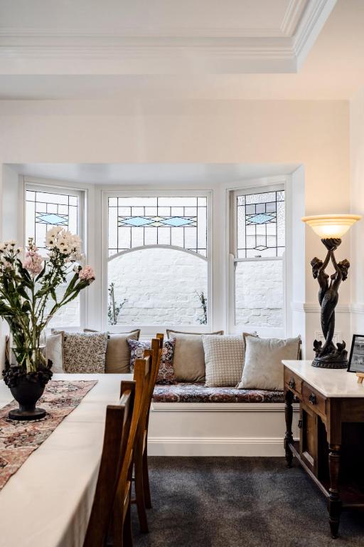 a living room with a couch in a window at Seaview House in Queenscliff