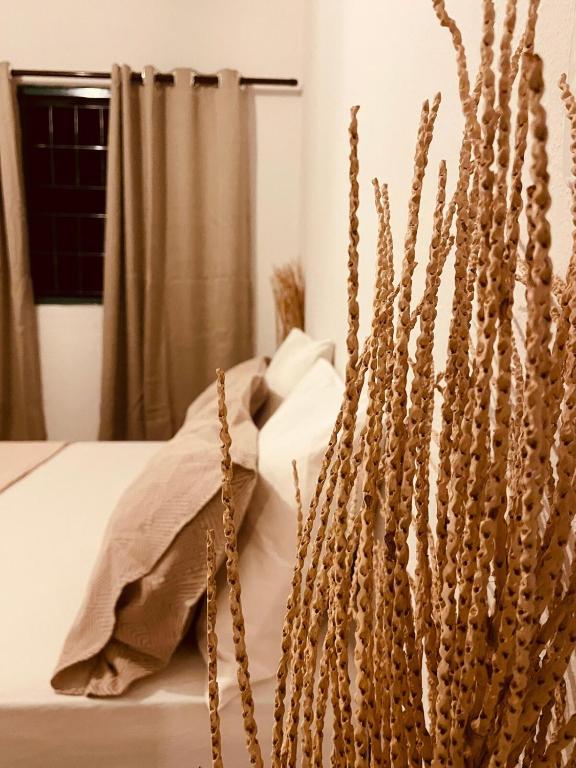 a bed with a bunch of gold chains on it at Casa Guiné in Goiás