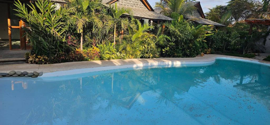 una piscina azul frente a una casa en Villas Boutique Antheia, en La Orilla
