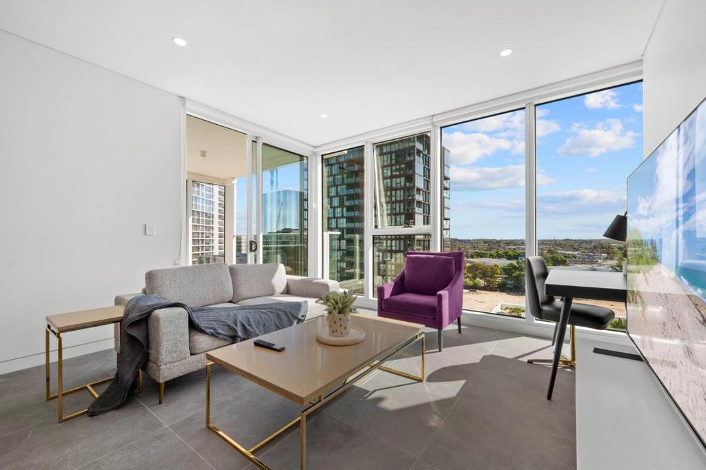 un salon avec un canapé et un piano dans l'établissement SOP 27 Stylish and Cozy 2 Bedroom Apartment, à Sydney