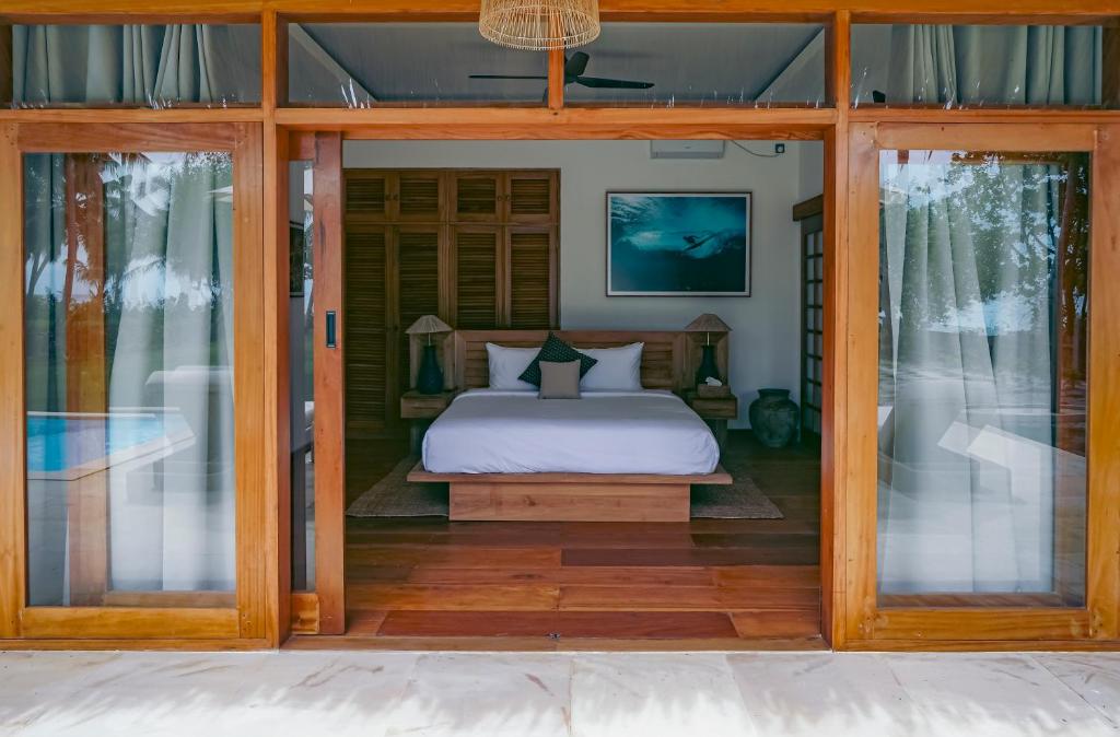 Postel nebo postele na pokoji v ubytování Villa Madu Mentawai