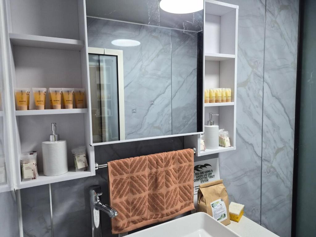 a bathroom with a sink and a mirror at Country Cottage of Yesteryear 