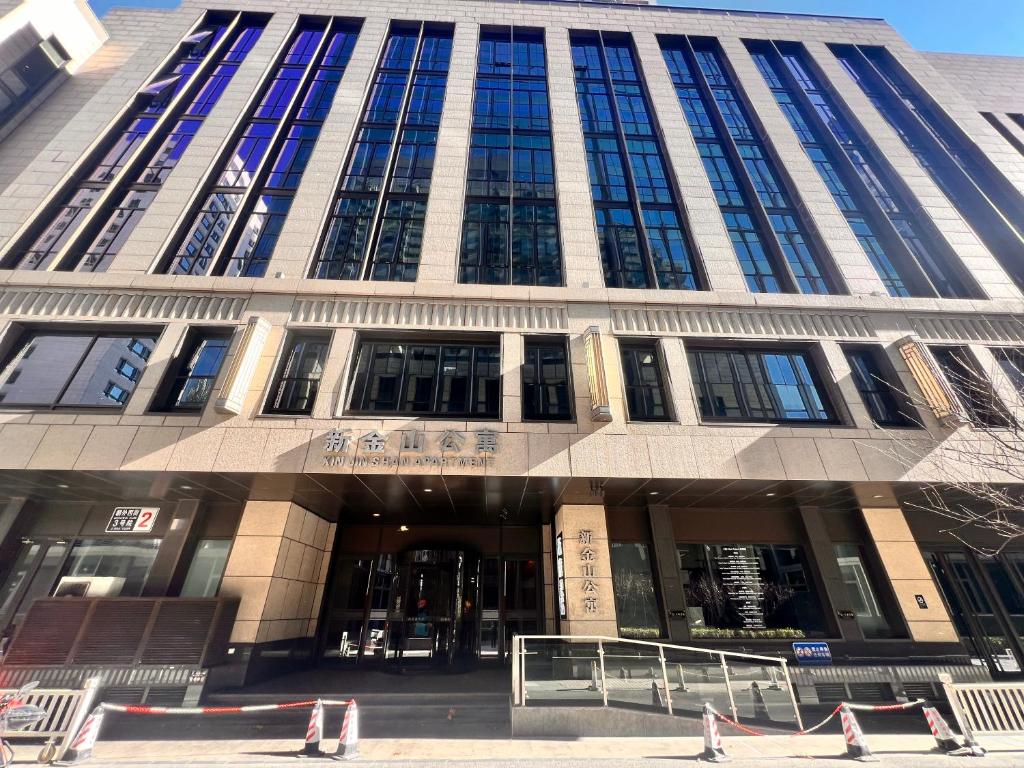 a large building with a lot of windows on it at New Jinshan Apartment in Beijing