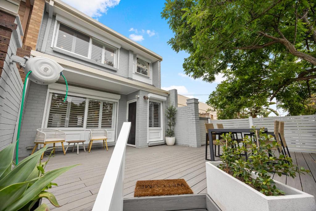 a patio with chairs and a house at Hazy Shores Escape - Breezy Coastal Stay near Henley Square in Henley Beach