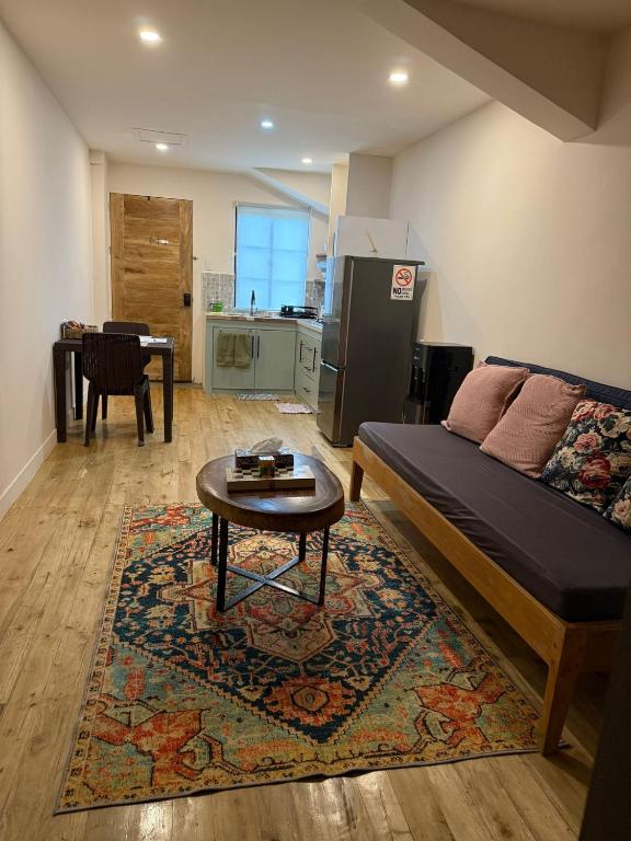 a living room with a bed and a coffee table at Studio Apartment in Port Barton in San Vicente