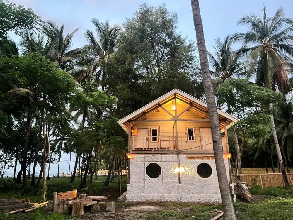 a small house with a balcony on top of it at Villa Lakdu in Sorongjukung