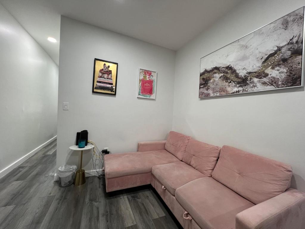 a living room with a brown couch in a room at VibeHaus Midtown in New York