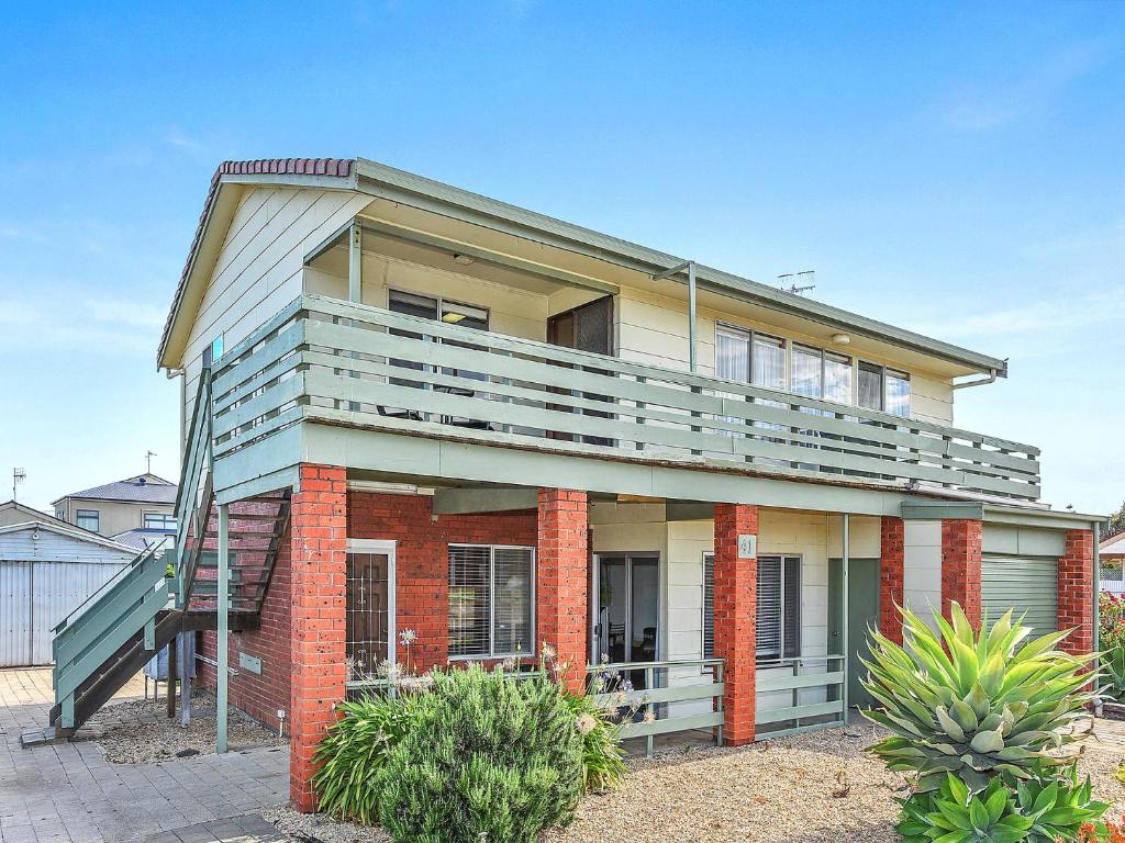 a house with a balcony on top of it at 41 Bailey Rd - Family - Surf Beach - No Linen Included in Middleton