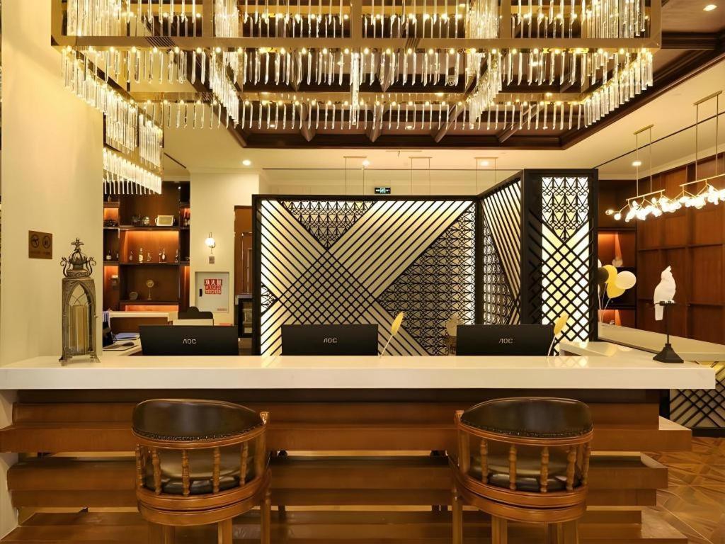 eine Bar mit zwei Stühlen und einer Theke mit Weingläsern in der Unterkunft James Joyce Coffetel Chengdu Longquan Dongfang Huada Plaza in Chengdu