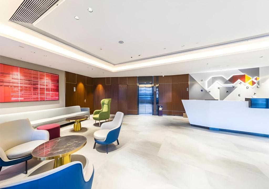 a lobby of a hotel with chairs and tables at Borrman Hotel Guangzhou Railway Station Sanyuanli Metro Station in Guangzhou