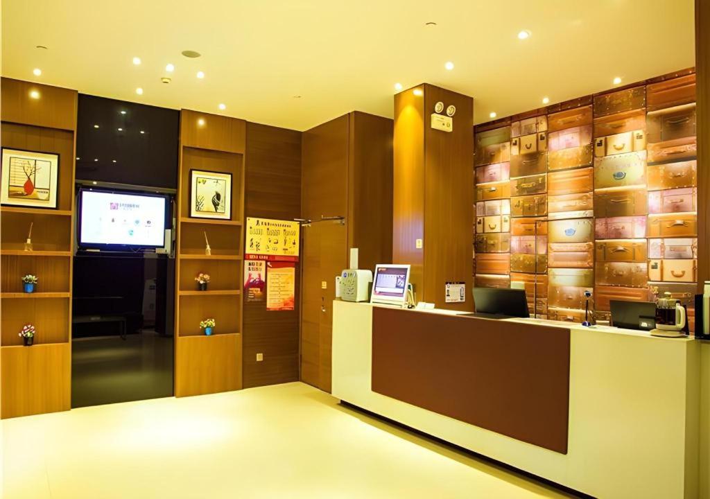 a room with a counter and a tv in a room at JTOUR Inn Wuzhou Arcade City Sanzongfu in Wuzhou