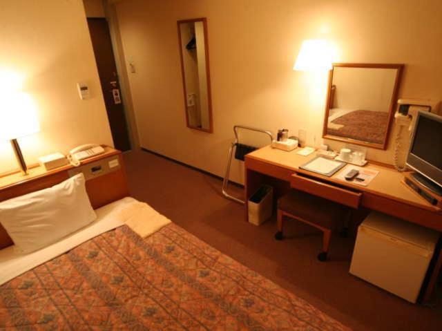 Postel nebo postele na pokoji v ubytování Hashimoto Park Hotel