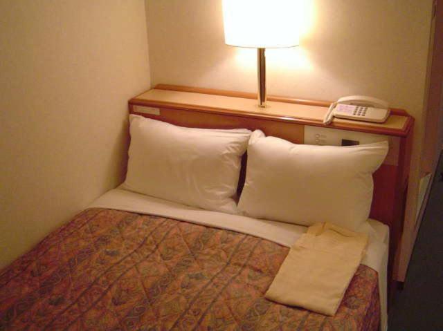 Postel nebo postele na pokoji v ubytování Hashimoto Park Hotel