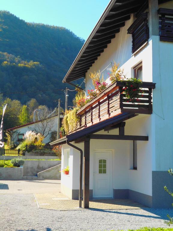 a building with a balcony with flowers on it at Apartma R Sport in Tolmin