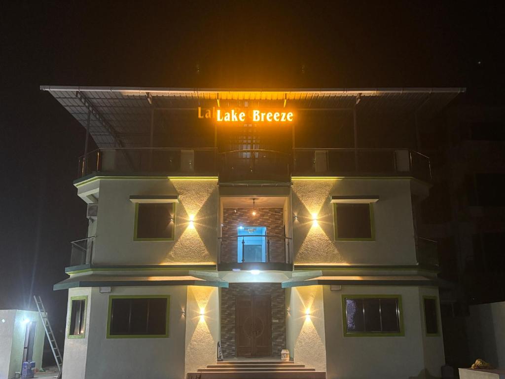 a building with a sign that says ill take beer at Lake Breeze Resort in Alibaug